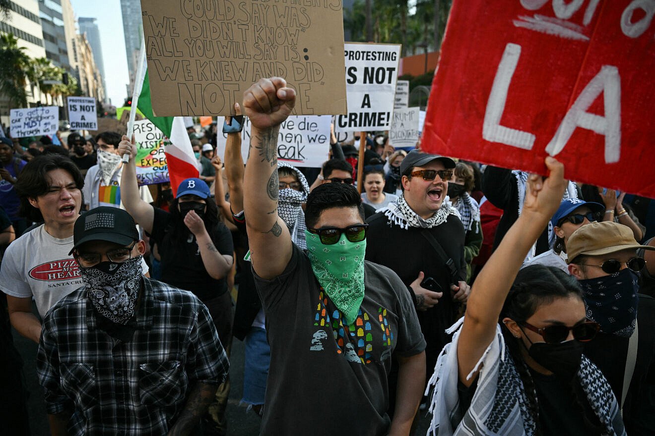 A man holds up a fist as anti-immigration protesters gather to demonstrate against federal immigration operations at Pershing Square in downtown Los Angeles, on June 11, 2025. Photo by Ronaldo Schemidt/AFP via Getty Images. A man holds up a fist as anti-immigration protesters gather to demonstrate against federal immigration operations at Pershing Square in downtown Los Angeles, on June 11, 2025. Photo by Ronaldo Schemidt/AFP via Getty Images.