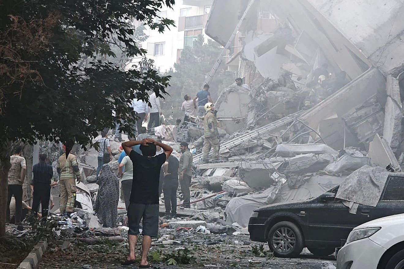 People look over damage to buildings in Nobonyad Square, Tehran, following Israeli airstrikes on June 13, 2025. Photo by Majid Saeedi/Getty Images.