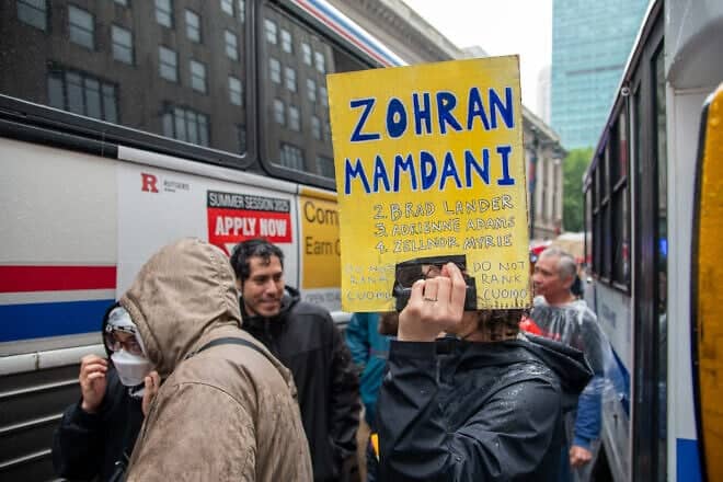 Demonstrator holds up a sign supporting New York state representative Zohran Mamdani ahead of the June 24 Democratic primary, during the "No Kings Protest" in New York City, June 14, 2025. Credit: 	Moonlightonasnowynight via Wikimedia Commons.