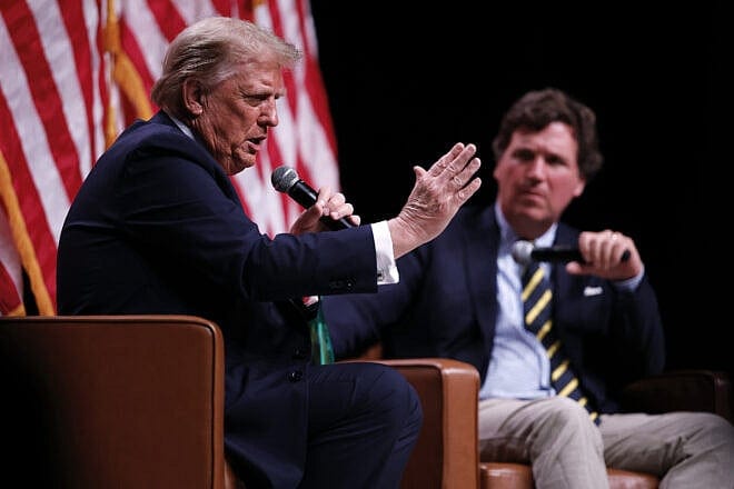A week before U.S. elections, GOP presidential nominee and former president Donald Trump sits down for a conversation with political commentator Tucker Carlson during his Live Tour at the Desert Diamond Arena in Phoenix, Ariz, Oct. 31, 2024. Photo by Chip Somodevilla/Getty Images.