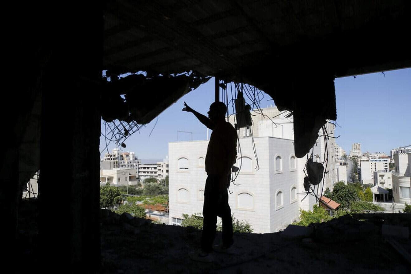 A man inspects the wreckage after the IDF partially demolished the home of Palestinian terrorist Abed Qader Qawasmi in Hebron in Judea on May 21, 2025. Photo by WIsam Hashlamoun/Flash90.