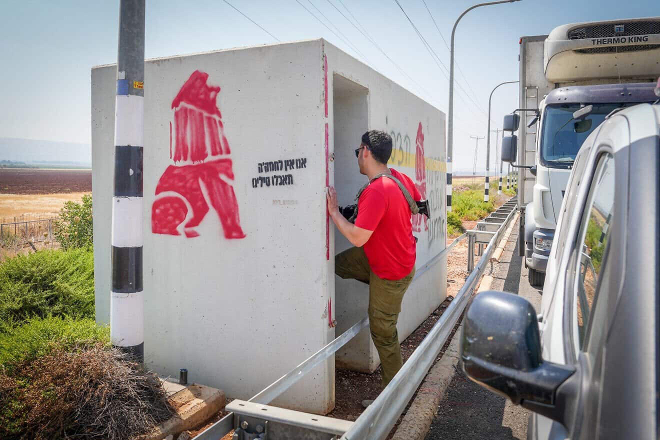 People run to take cover in a protection room by the roadside of Highway 90 as an alarm is sounded warning of incoming ballistic missiles fired from Iran into Israel. June 23, 2025. Photo by Ayal Margolin/Flash90.