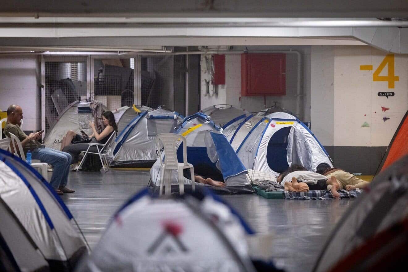 People take shelter in an underground parking lot in Tel Aviv during the war between Israel and Iran, June 24, 2025. Photo by Chaim Goldberg/Flash90.