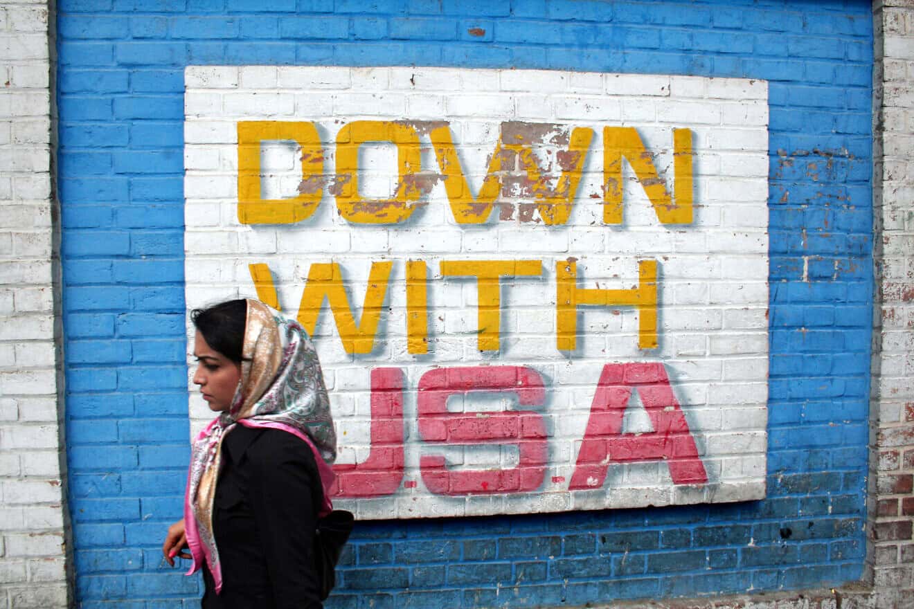 A woman walks past the site of the former U.S. Embassy in Tehran, where anti-American graffiti appears on Sept. 29, 2007. Credit: Örlygur Hnefill via Wikimedia Commons.