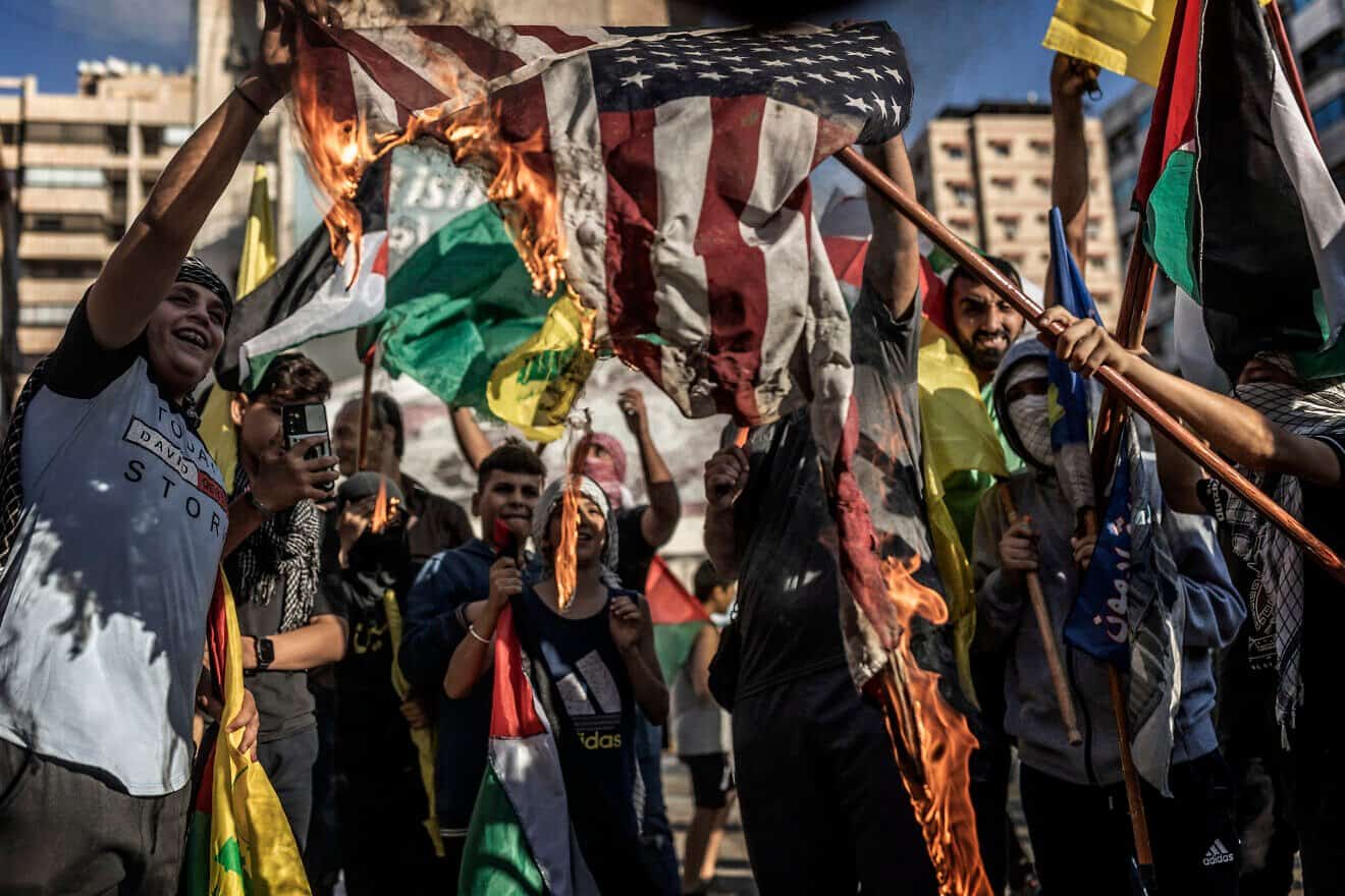 Hezbollah terrorist supporters burn an American flag during a rally in support of Hamas in Beirut, Oct. 20, 2023. Photo by Manu Brabo/Getty Images.