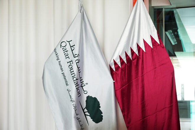 The flag of the Qatar Foundation is seen alongside the Qatar flag during the AFC Asian Cup in Al Rayyan, Qatar, on Feb. 4, 2024. Photo by Etsuo Hara/Getty Images.