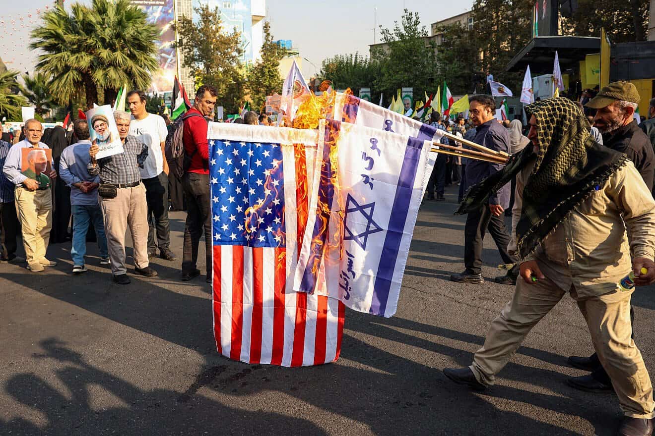 Iranians burn Israeli and U.S. flags during an anti-Israel rally in Tehran, on Oct. 8, 2024. Photo by AFP via Getty Images.