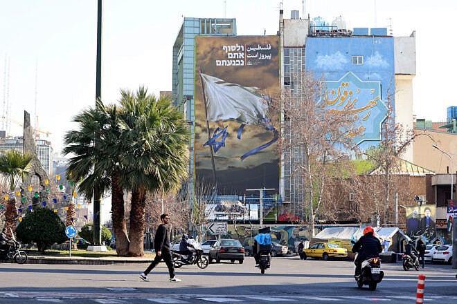 Iranians walk past an anti-Israel billboard at Tehran's Palestine Square, Jan. 22, 2025. Photo by Atta Kenare/AFP via Getty Images.