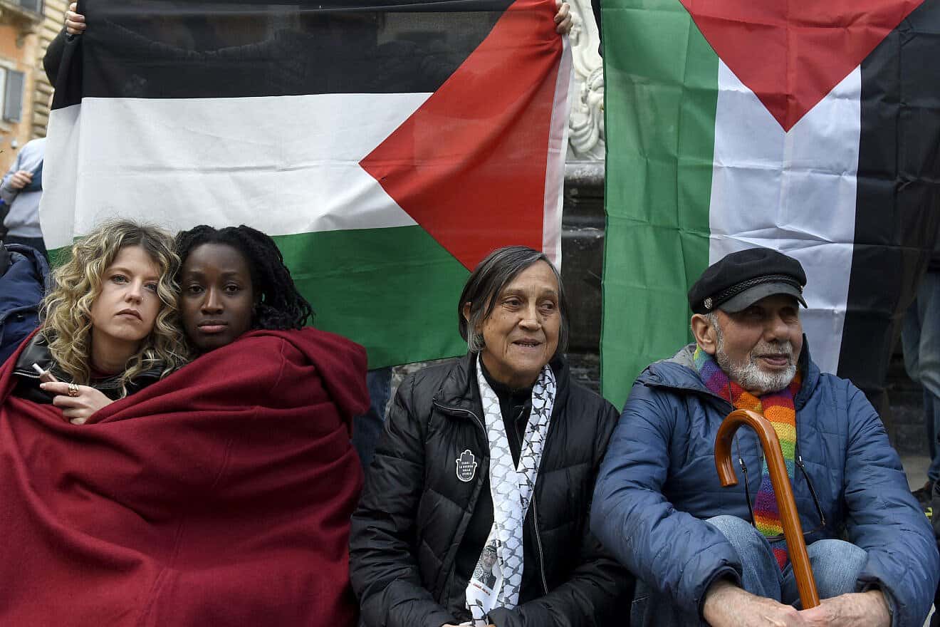 Two girls hug in front of a Palestinian flag during a demonstration in Rome's Piazza della Rotonda in solidarity with the Palestinians and against Israel's war, on March 20, 2025. Photo by Simona Granati-Corbis/Corbis via Getty Images.