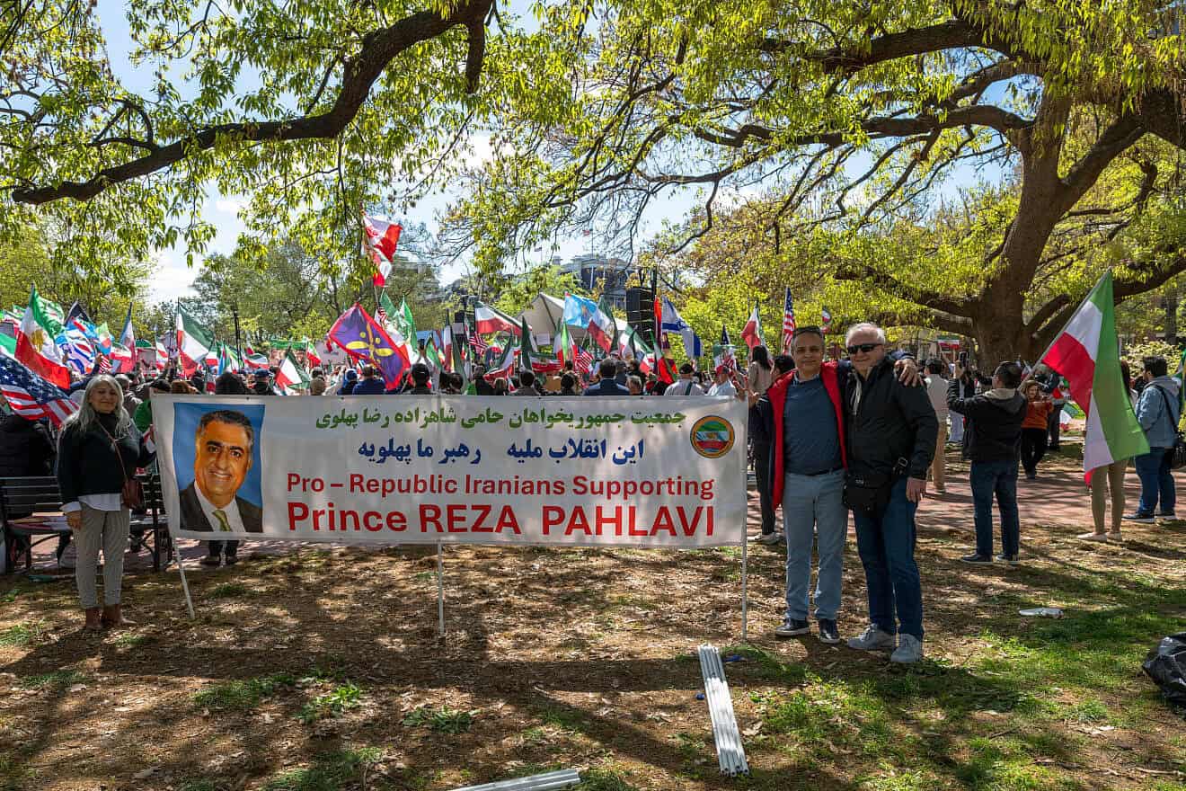 Members of the group Pro-Republic Iranians Supporting Prince Reza Pahlavi pose with a large banner in front of the White House during a rally in Washington, D.C. on April 13, 2025. The banner features a portrait of Crown Prince Reza Pahlavi and messages of support in both Persian and English. Demonstrators behind them wave pre-1979 Iranian flags, American flags, and other symbols of solidarity, calling for regime change in Iran. (Photo by Matt Kargar/Middle East Images/AFP via Getty Images)