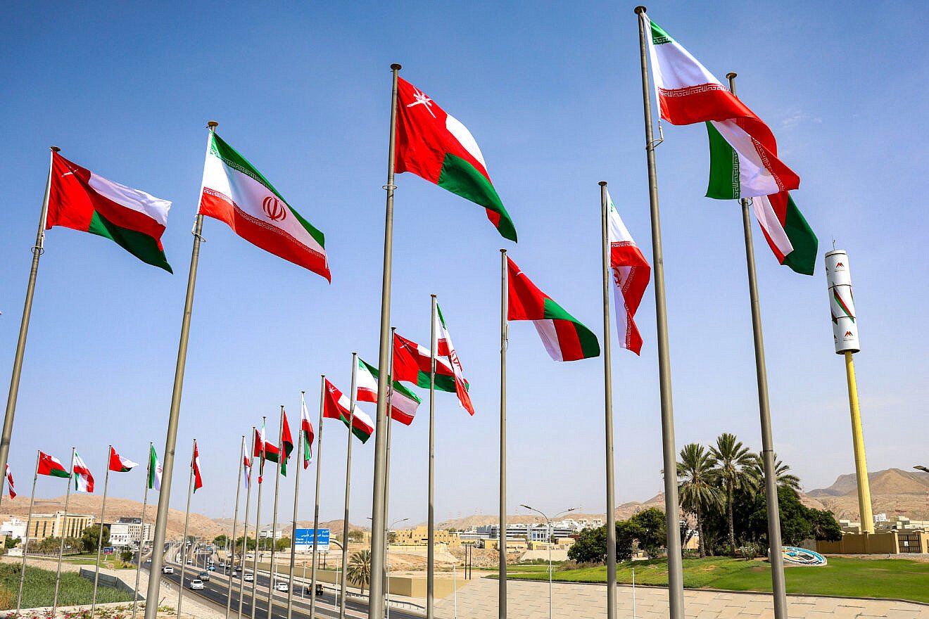 The flags of Oman and Iran fly along a highway in Muscat during the visit of the Iranian president on May 27, 2025. Photo by Haitham al-Shukairi/AFP via Getty Images.