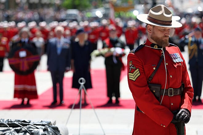 Royal Canadian Mounted Police (RCMP) officer stands guard as Britain's King Charles III and Queen Camilla attend a wreath laying ceremony at the Tomb of the Unknown Soldier at the National War Memorial on May 27, 2025 in Ottawa, Canada. Photo by Hannah McKay, Pool/Getty Images.