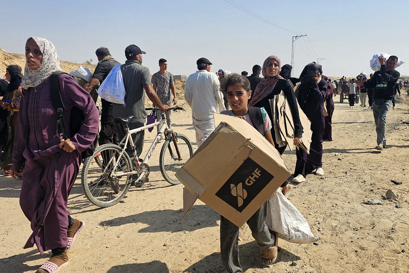 Palestinians walk along a road to receive humanitarian aid packages from the U.S.-backed Gaza Humanitarian Foundation in Rafah in the southern Gaza Strip on June 5, 2025. Photo by AFP via Getty Images.