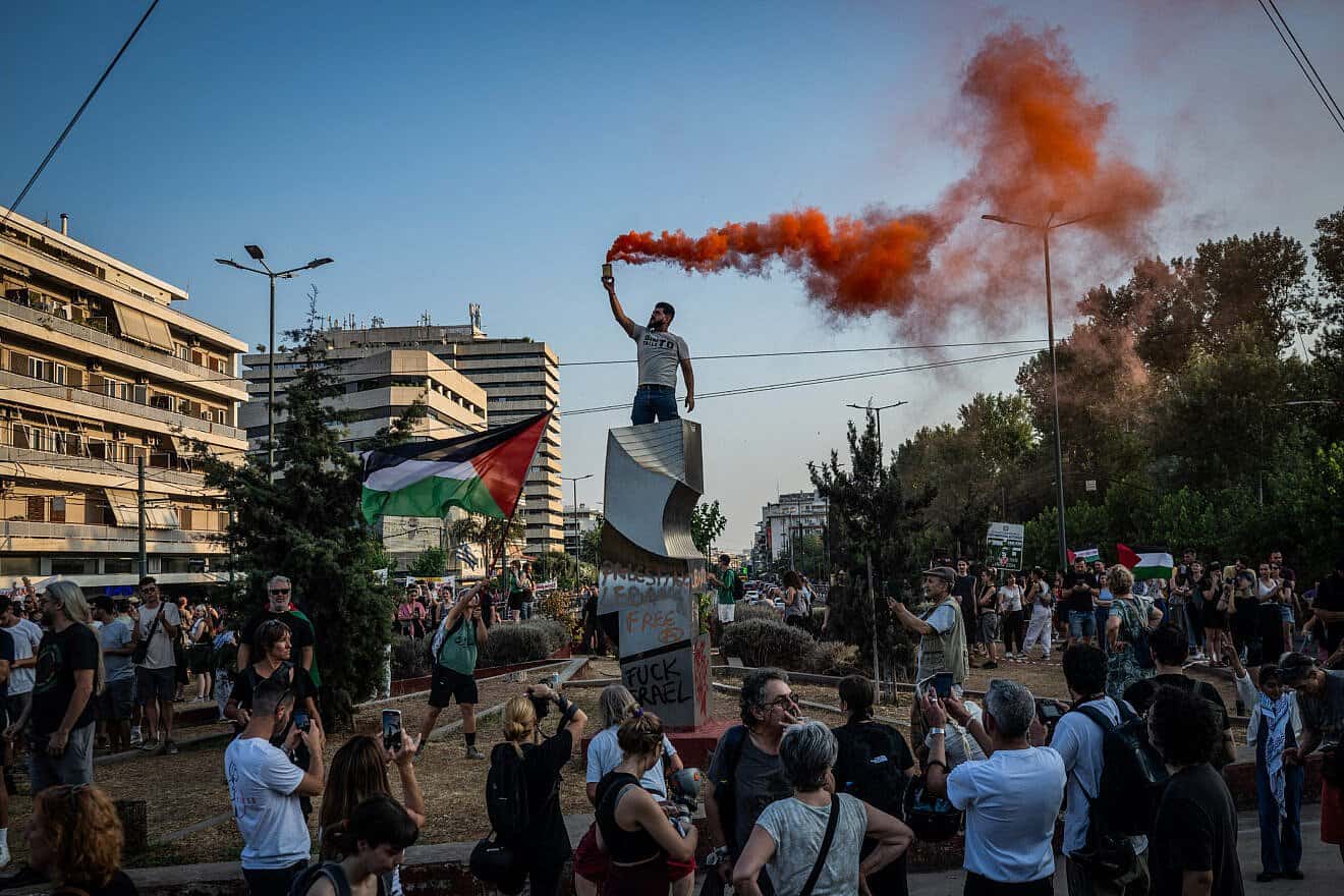 Protesters display Palestinian flags and signs during a demonstration outside the Israeli embassy in Athens, Greece, on June 9, 2025. Photo by Angelos Tzortzinis/AFP via Getty Images.