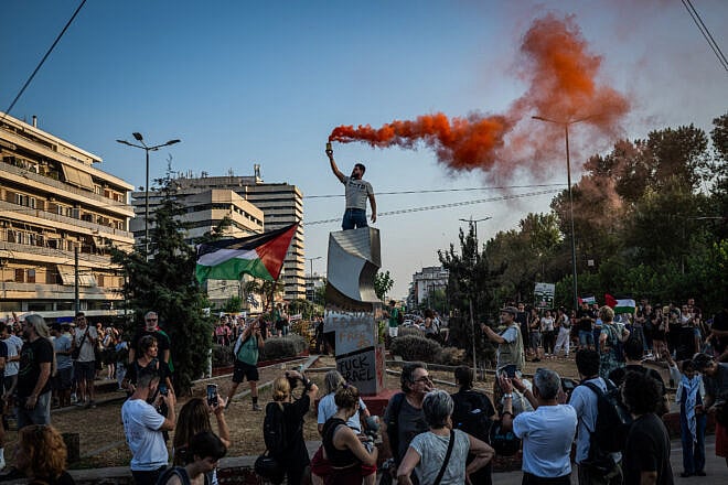Protesters display Palestinian flags and signs during a demonstration outside the Israeli embassy in Athens, Greece, on June 9, 2025. Photo by Angelos Tzortzinis/AFP via Getty Images.