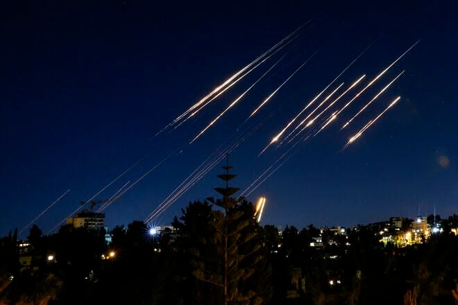 Missiles fired from Iran are pictured in the night sky over Jerusalem on June 14, 2025. Photo by Menahem Kahana/AFP via Getty Images)