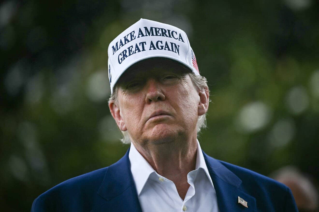 U.S. President Donald Trump speaks to the press as workers install a large flag pole on the South Lawn of the White House, June 18, 2025. Photo by Brendan Smialowski/AFP via Getty Images.