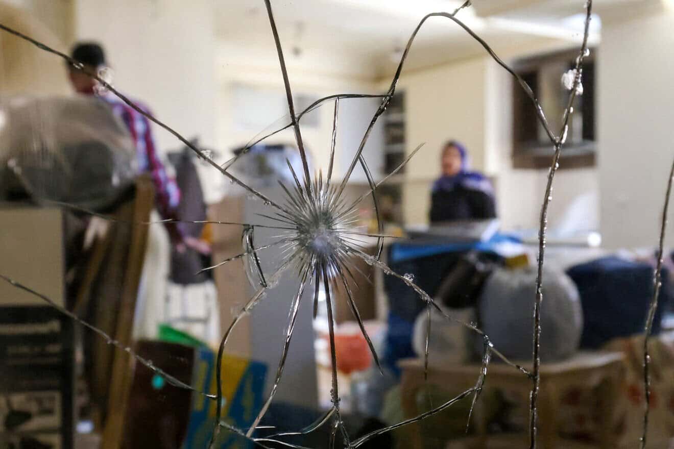 Residents collect their belongings in an apartment building that was hit in an Israeli strike on Tehran, on June 25, 2025. Photo by Atta Kenare/AFP via Getty Images.