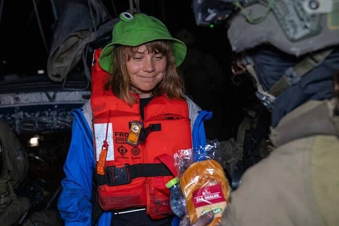 An Israeli soldier offers food and water to activist Greta Thunberg aboard the intercepted Gaza-bound yacht. Credit: Israel Foreign Ministry.