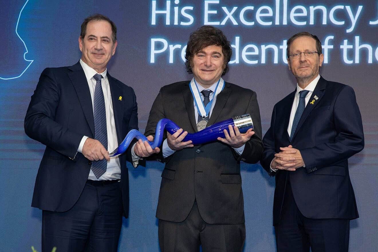 Argentinian President Javier Milei receive the Genesis Prize in Jerusalem, flanked by Israeli President Isaac Herzog, and co-founder and chairman of the Genesis Prize Foundation Stan Polovets, on June 12, 2025. Credit: Courtesy of Getty Images for the Genesis Prize Foundation.