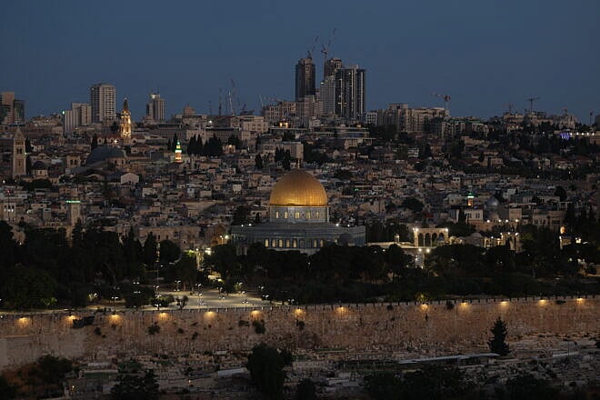 The sun rises over Jerusalem following Israeli Prime Minister Benjamin Netanyahu's announcement that a military operation was launched against Iran, targeting nuclear and military sites in Iran early on June 13, 2025. Photo by AHMAD GHARABLI/AFP via Getty Images.
