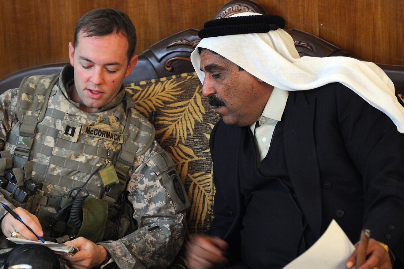 U.S. Army Capt. Nathan McCormack from Dallas, Texas, holds a meeting at Sheik Mohammad Hasan Falah's house about the economy of Al Butoma, Iraq, on Dec. 15, 2008. Credit: Sgt. Kani Ronningen/U.S. Army photo.