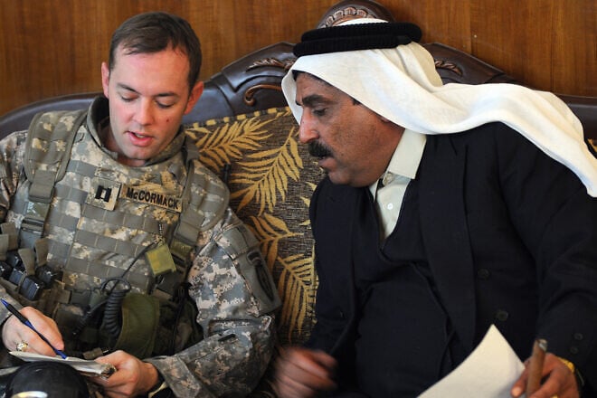 U.S. Army Capt. Nathan McCormack from Dallas, Texas, holds a meeting at Sheik Mohammad Hasan Falah's house about the economy of Al Butoma, Iraq, on Dec. 15, 2008. Credit: Sgt. Kani Ronningen/U.S. Army photo.