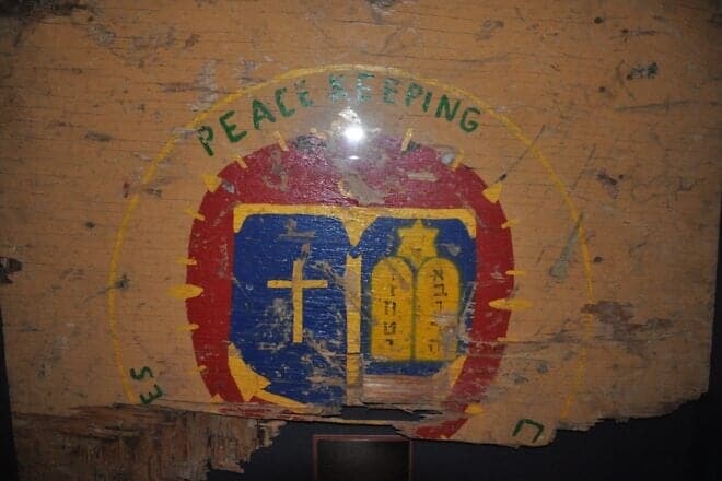 The sign for the Peacekeeping Chapel in Beirut during the time that U.S. forces were part of the International Peacekeeping Force. On Oct. 23, 1983, when a suicide bomber drove a truck laden with explosions into the Marine Barracks, this portion of the sign survived. It is part of the historical collection at the U.S. Naval Chaplaincy School and Center, on the campus of the Armed Forces Chaplaincy Center at Fort Jackson in Columbia, S.C. Credit: Archivist, U.S. Naval Chaplaincy School via Wikimedia Commons.