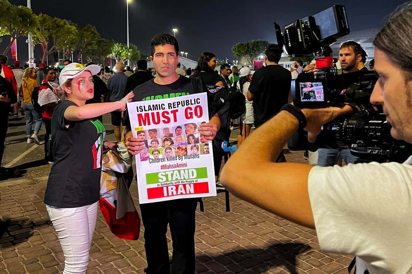 An Iranian fan with a protest banner at the World Cup in Berlin, Nov. 21, 2022. Credit: Standardwhale via Wikimedia Commons.