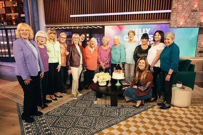 Women who reside in the Jack M. Satter House Hebrew SeniorLife residence in Revere, Mass., who modeled for the “Spectacular Seniors” 2025 calendar (project manager Rabbi Lior Nivo is sixth from left), are guests and VIPs on “The Kelly Clarkson Show,” April 24, 2025. Photo by Weiss Eubanks/NBCUniversal.