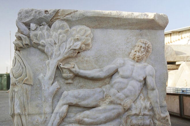 Hercules sprawled on a lion’s skin, seen on the side of the marble sarcophagus found in Caesarea in April 2025. Photo by Emil Aladjem/Israel Antiquities Authority.