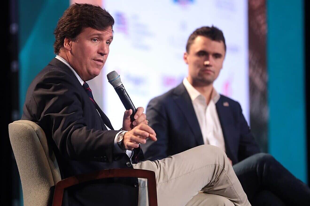 Conservative talk-show host Tucker Carlson and Charlie Kirk, a conservative political activist, author and right-wing populist media personality, speak with attendees at the 2018 Student Action Summit hosted by Turning Point USA at the Palm Beach County Convention Center in West Palm Beach, Fla., Dec. 22, 2018. Credit: Gage Skidmore via Wikimedia Commons.