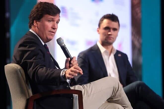Conservative talk-show host Tucker Carlson and Charlie Kirk, a conservative political activist, author and right-wing populist media personality, speak with attendees at the 2018 Student Action Summit hosted by Turning Point USA at the Palm Beach County Convention Center in West Palm Beach, Fla., Dec. 22, 2018. Credit: Gage Skidmore via Wikimedia Commons.