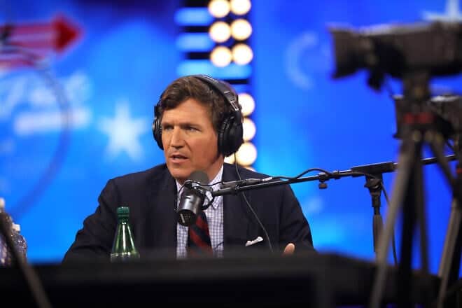 Tucker Carlson speaking with attendees at the 2023 AmericaFest at the Phoenix Convention Center in Phoenix, Ariz. Credit: Gred Skidmore via Wikimedia Commons.