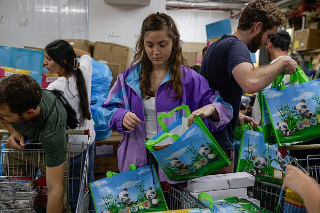 Young volunteers pack kits to distribute to young families in Jerusalem amid war between Israel and Iran, June 15, 2025. Photo by Rachel Alroey/Flash90.