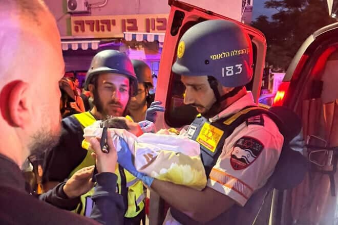 Dr. Gal Rosen (right) examines a 6-day-old girl in Tel Aviv on June 16, 2025. Credit: Courtesy of Magen David Adom.