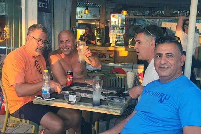 Ron Hazan raises a glass with friends at Moshav Shavei Tzion in the Western Galilee on June 24, 2025. Photo by Canaan Lidor.