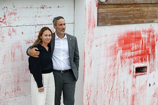 Alex and Vicki Ryvchin stand outside their vandalized former home in Sydney in January. Credit: Courtesy of Alex Ryvchin.