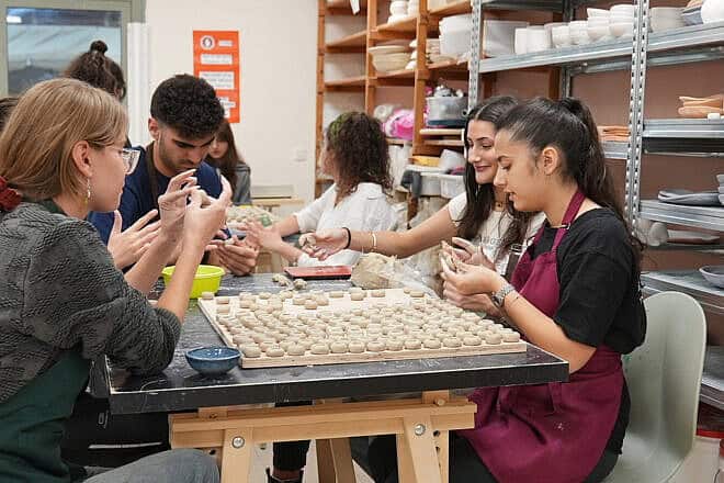 Participating youth at work in the Quantum program, creating custom items to be sold. Credit: Courtesy of Goldie Sternbuch.