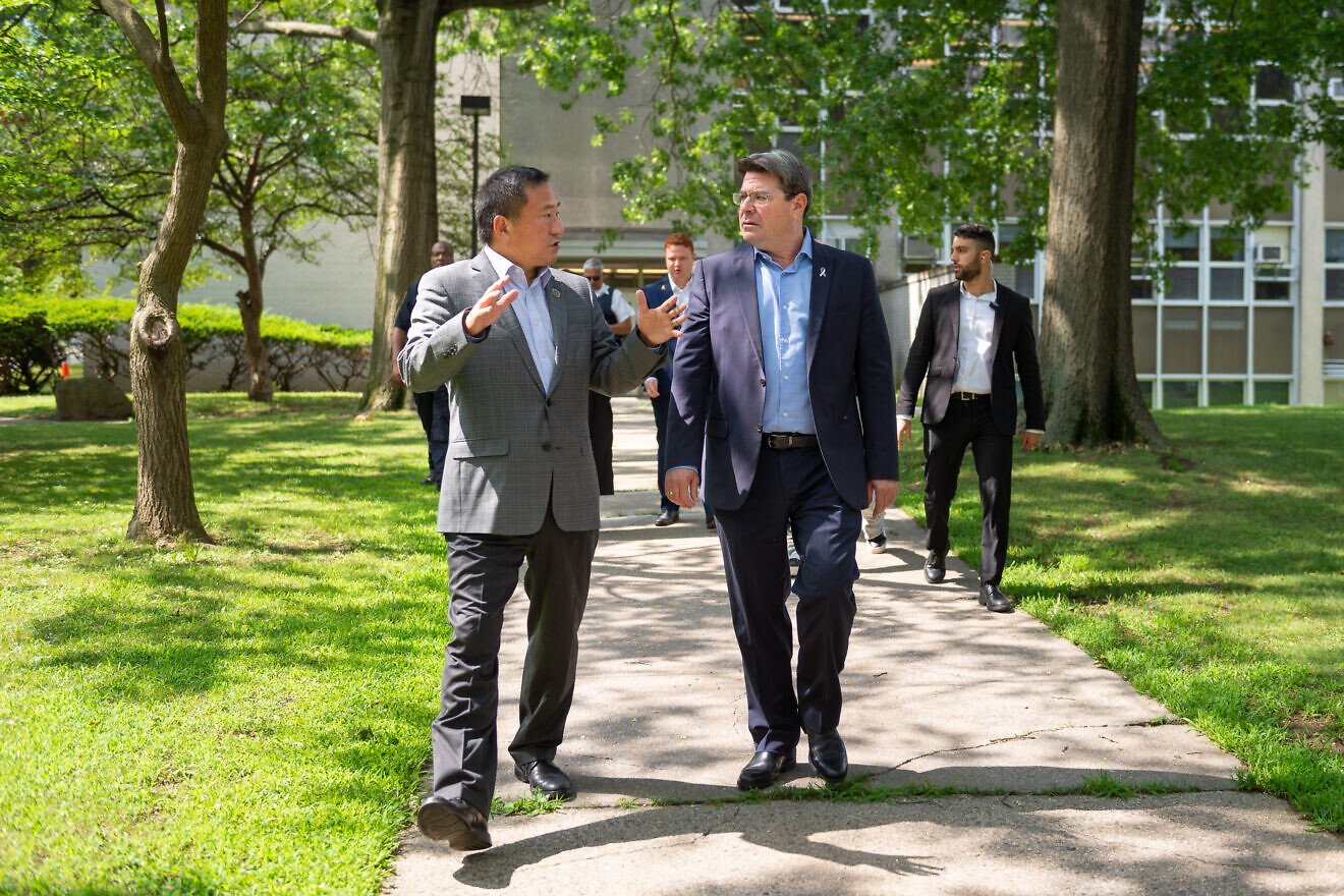 Ofir Akunis (right), the consul general of Israel in New York, talks with Frank Wu, president of Queens College, on the college's campus, July 16, 2025. Credit: Andy Poon/Queens College.