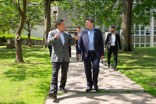 Ofir Akunis (right), the consul general of Israel in New York, talks with Frank Wu, president of Queens College, on the college's campus, July 16, 2025. Credit: Andy Poon/Queens College.