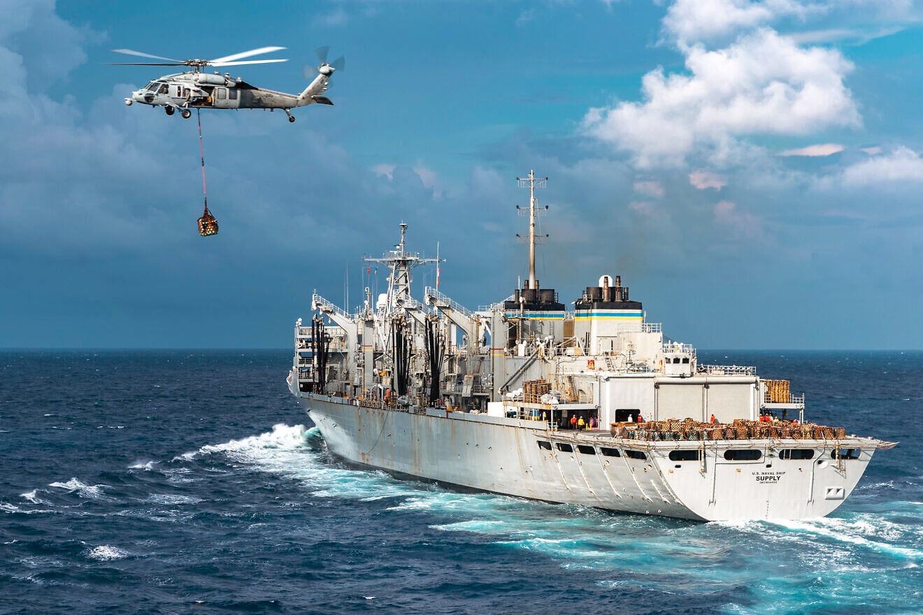 A U.S. Navy MH-60S Sea Hawk helicopter transfers cargo from the USNS “Supply,” bound for the USS “Gerald R. Ford,” the world's largest aircraft carrier, during a replenishment in the Atlantic Ocean, July 9, 2025. Credit: Mass Communication Specialist Seaman Brianna Barnett/U.S. Navy Photo.