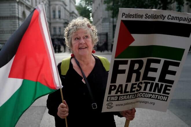 An anti-Israel protester with a PLO flag opposite Downing Street, London, on June 5, 2018. Photo by Alisdare Hickson.