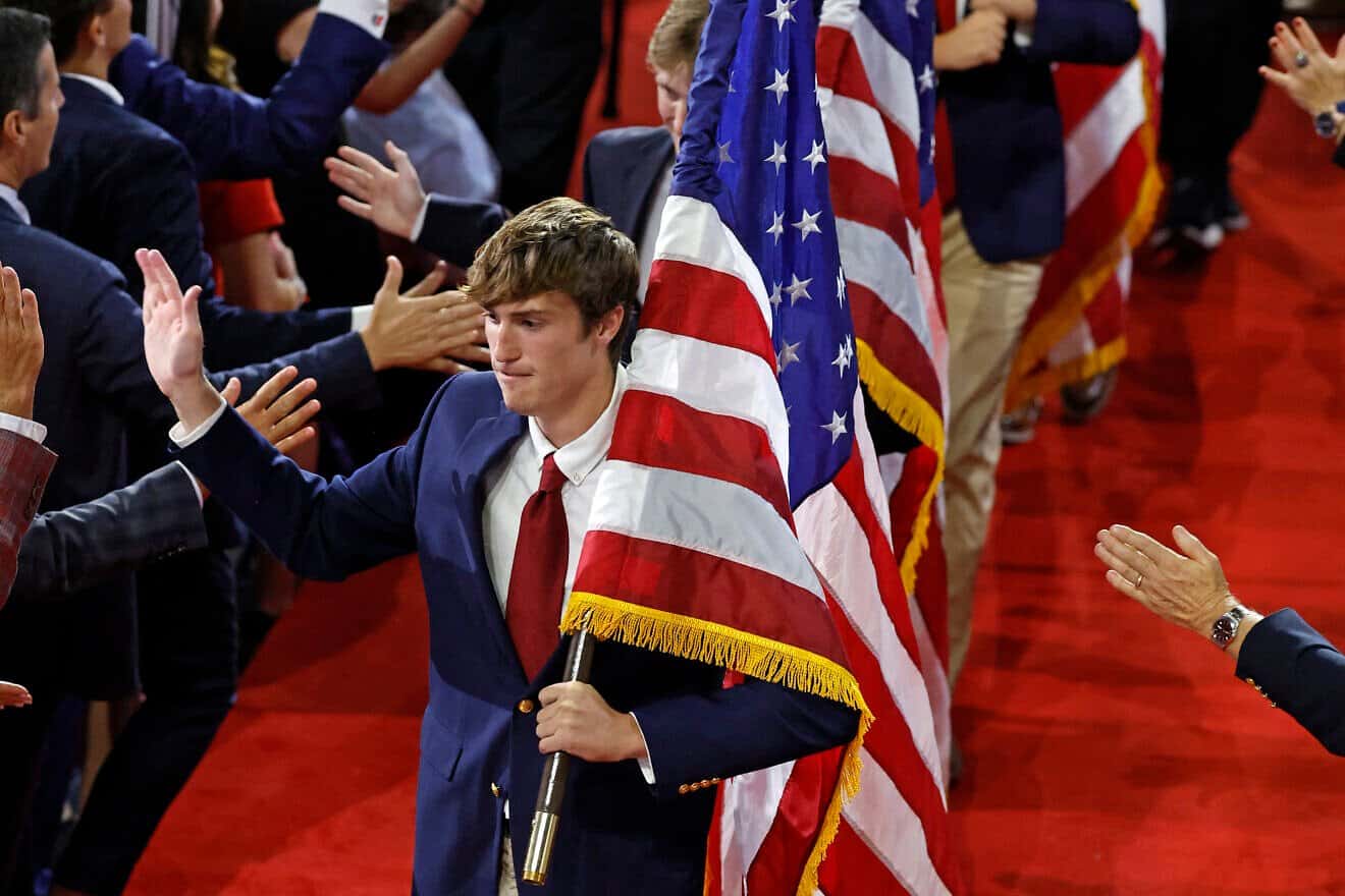 Fraternity brothers from the University of North Carolina at Chapel Hill holding American flags greet attendees at the third day of the 2024 Republican National Convention at the Fiserv Forum in Milwaukee, Wis., on July 17, 2024. Photo by Kamil Krzaczynski/AFP via Getty Images.