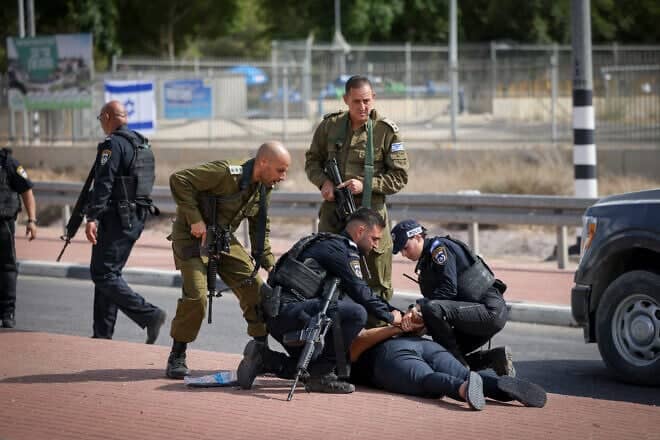 Soldiers and police arrest two Arab men on suspicion of looting, near Ofakim, southern Israel. Oct. 16, 2023. Photo by Chaim Goldberg/Flash90.