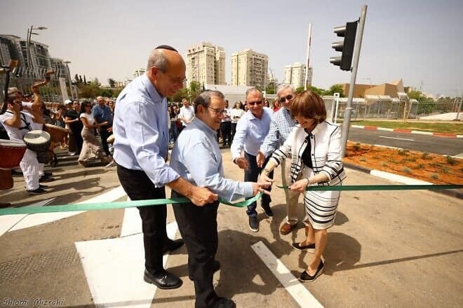 Zipora Schorr, a representative of the Haron Dahan Foundation, cuts the ribbon at the recent dedication ceremony for the new Aharon and Rachel Dahan Gate at Bar-Ilan University in Ramat Gan, Israel. Also pictured are foundation president Rabbi Mitchell Wohlberg (center), and (left) university president Arie Zaban. Photo by Shlomi Mizrahi.