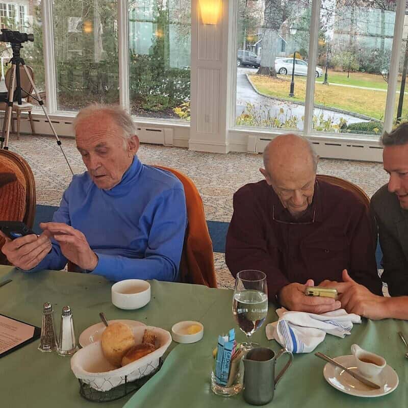 Dan Rosen (right), co-founder and co-chair of the new Emissary app, teaches Jewish community members how to use it. Credit: Courtesy.