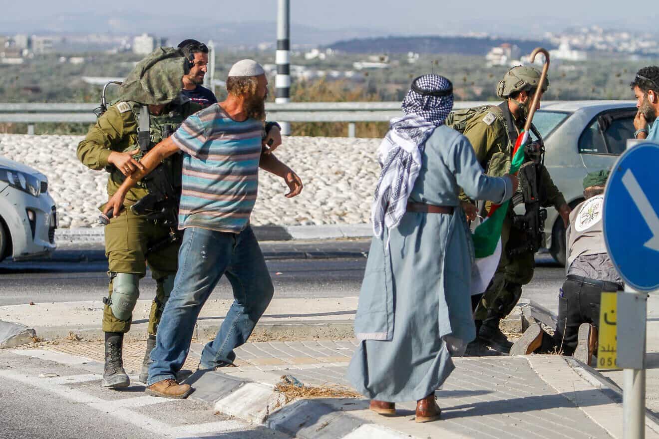 Palestinians confront a Jewish man during a protest against Israeli areas near Qalqilya, on Aug. 12, 2022. Photo by Nasser Ishtayeh/Flash90.