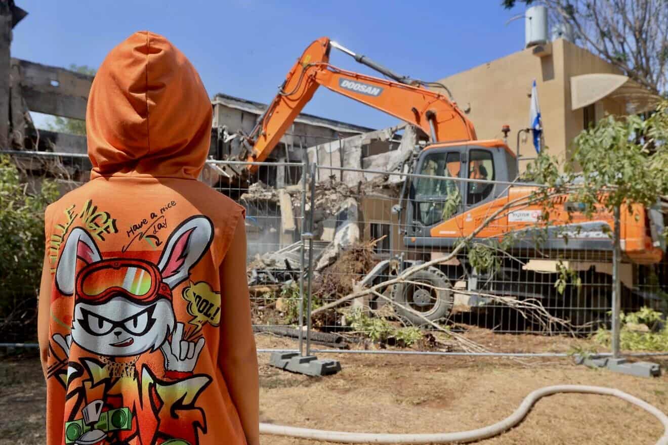 A bulldozer destroys a house that was damaged during the Oct. 7, 2023, massacre in Kibbutz Be'eri, near the Israeli border with the Gaza Strip, July 7, 2024. Photo by Oren Cohen/Flash90.