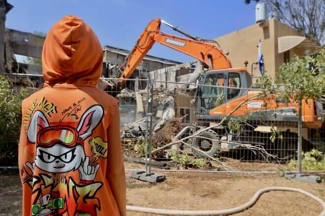 A bulldozer destroys a house that was damaged during the Oct. 7, 2023, massacre in Kibbutz Be'eri, near the Israeli border with the Gaza Strip, July 7, 2024. Photo by Oren Cohen/Flash90.